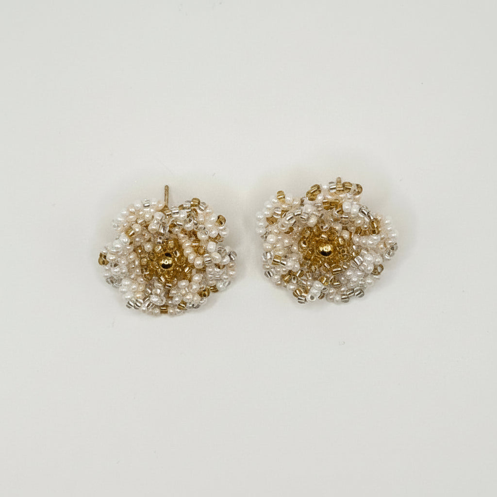 A pair of small beaded flower-shaped earrings with white pearl-like beads and gold metallic accents, displayed on a clean white background.