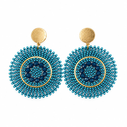 A pair of gold-tone and turquoise blue beaded dangle earrings on a white display card, photographed against a white background.
