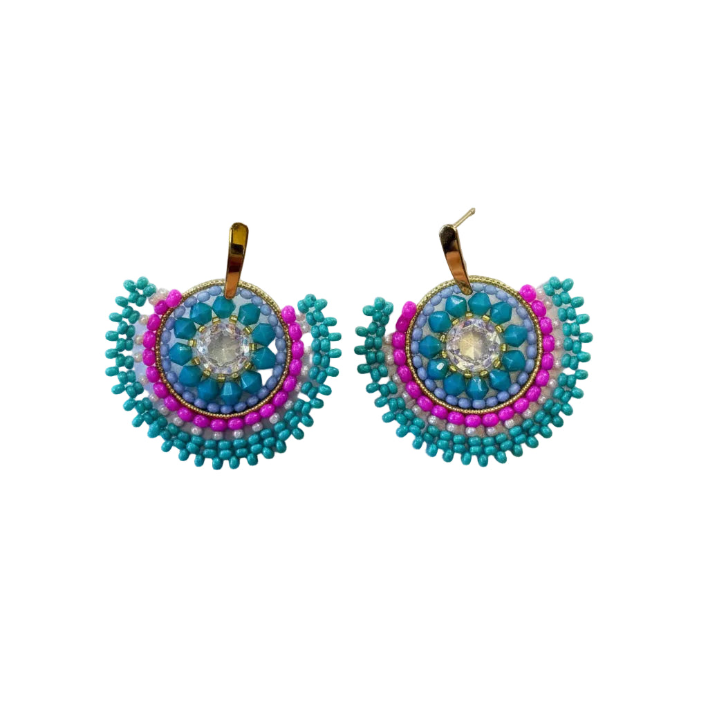 A pair of handmade beaded earrings with turquoise blue, pink, and purple beads, featuring a gold-tone hook back, displayed on a light off-white background.