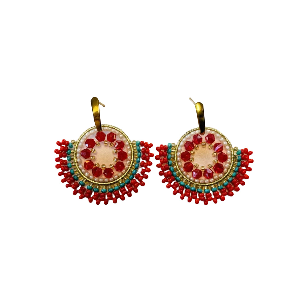 A pair of handmade bohemian earrings featuring red beaded semicircles with gold-tone metal hoops and turquoise blue bead accents, displayed on a white surface.