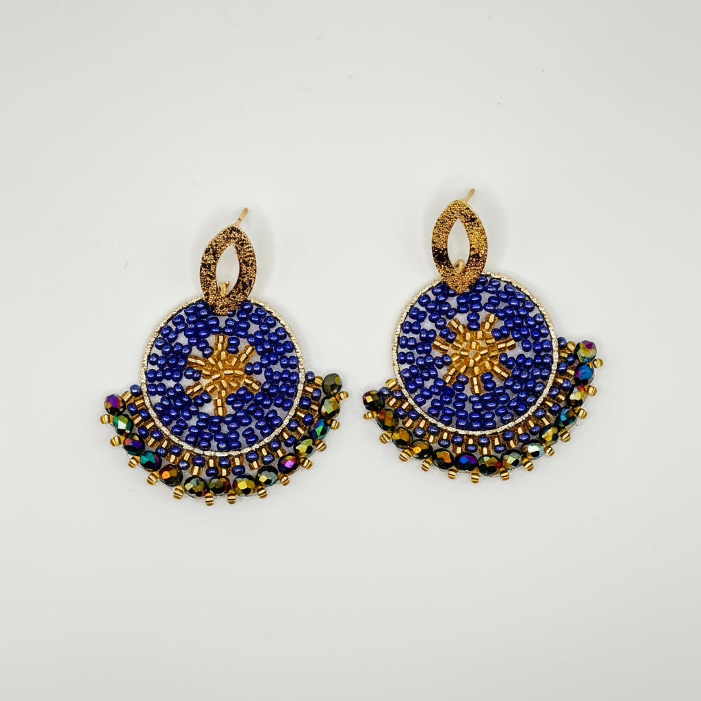 A pair of traditional Indian Kundan earrings featuring deep blue stone inlay, gold-plated metal borders, and small multicolored rhinestone accents, displayed on a clean white background.