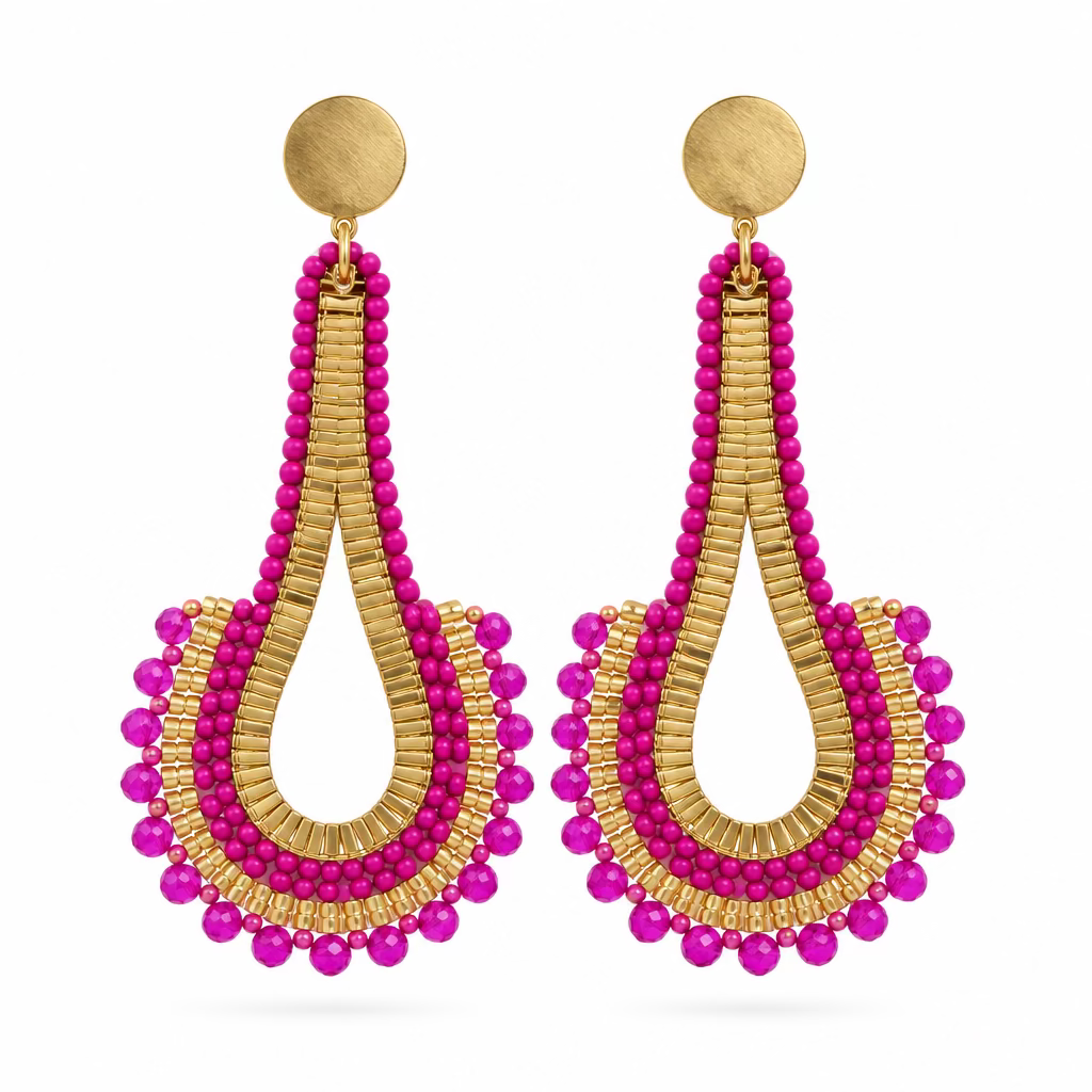 A pair of long teardrop-shaped dangling earrings with bright pink beaded edges and gold-toned woven centers, displayed on a white plastic jewelry stand against a plain light background.