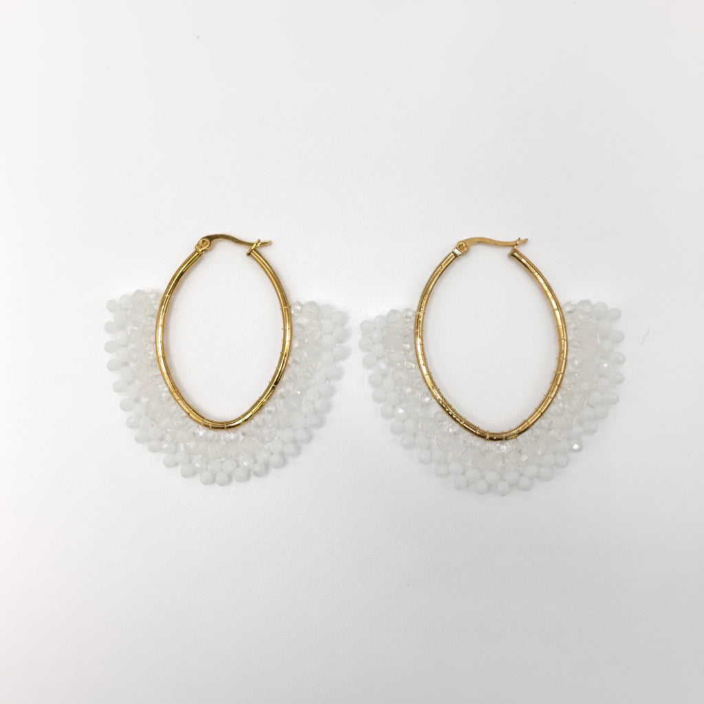 Gold hoop earrings with white beaded accents