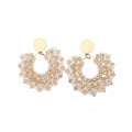 Pair of gold hoop earrings with pearl-like beads 