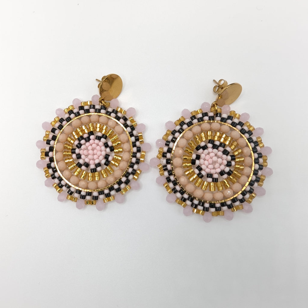 Pair of round earrings with gold, pink, and black design
