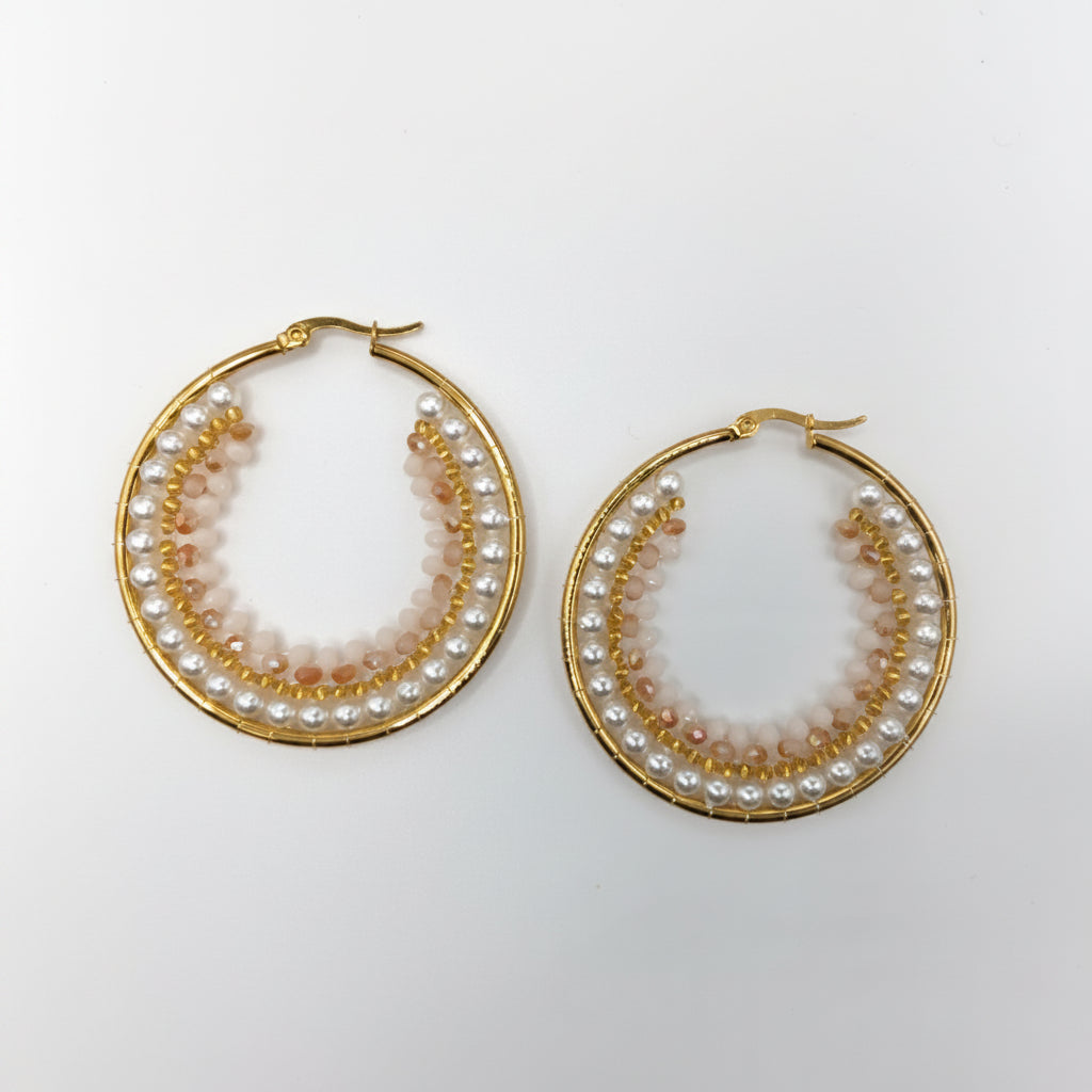 Gold hoop earrings with pearl accents