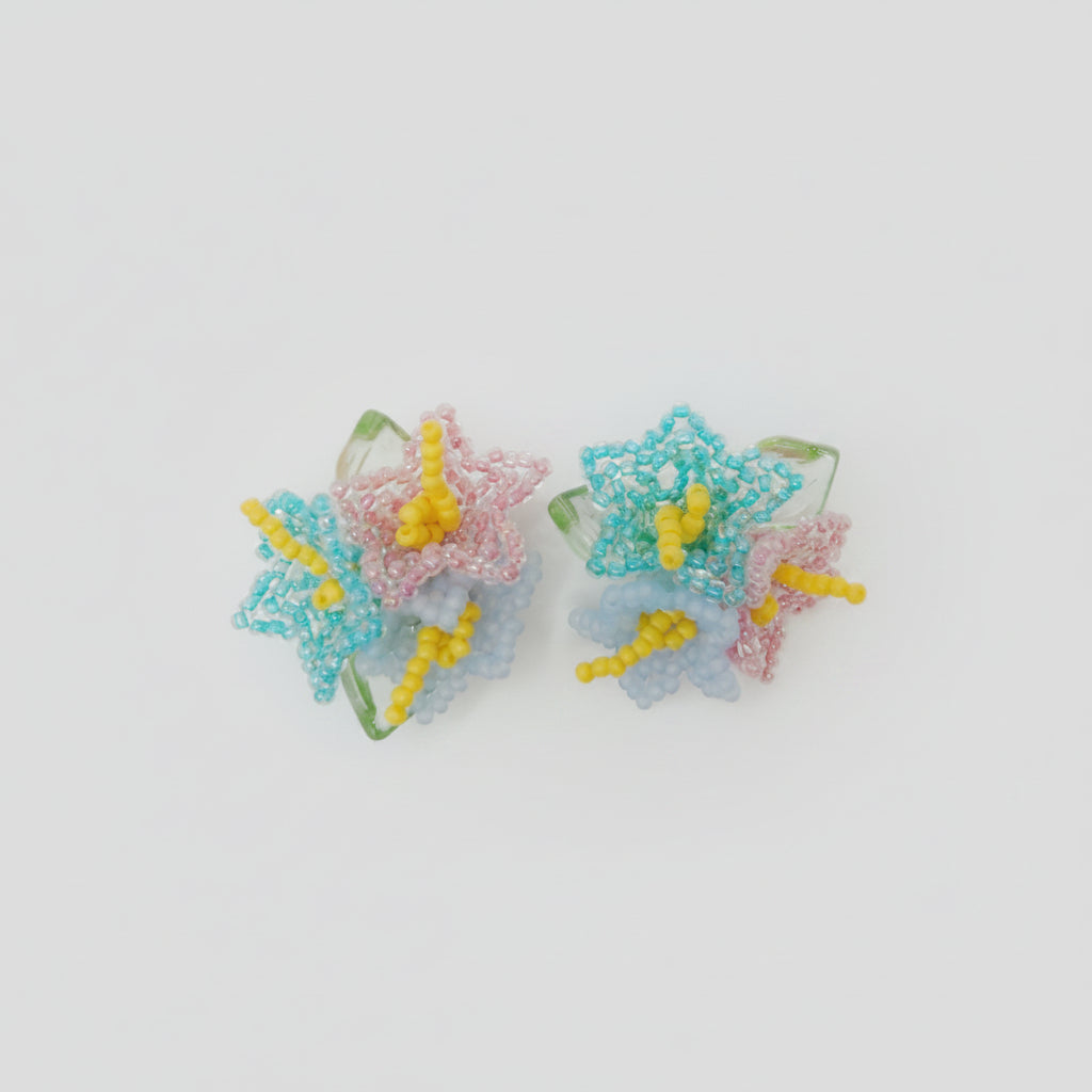 Pair of colorful butterfly-shaped earrings on a white background