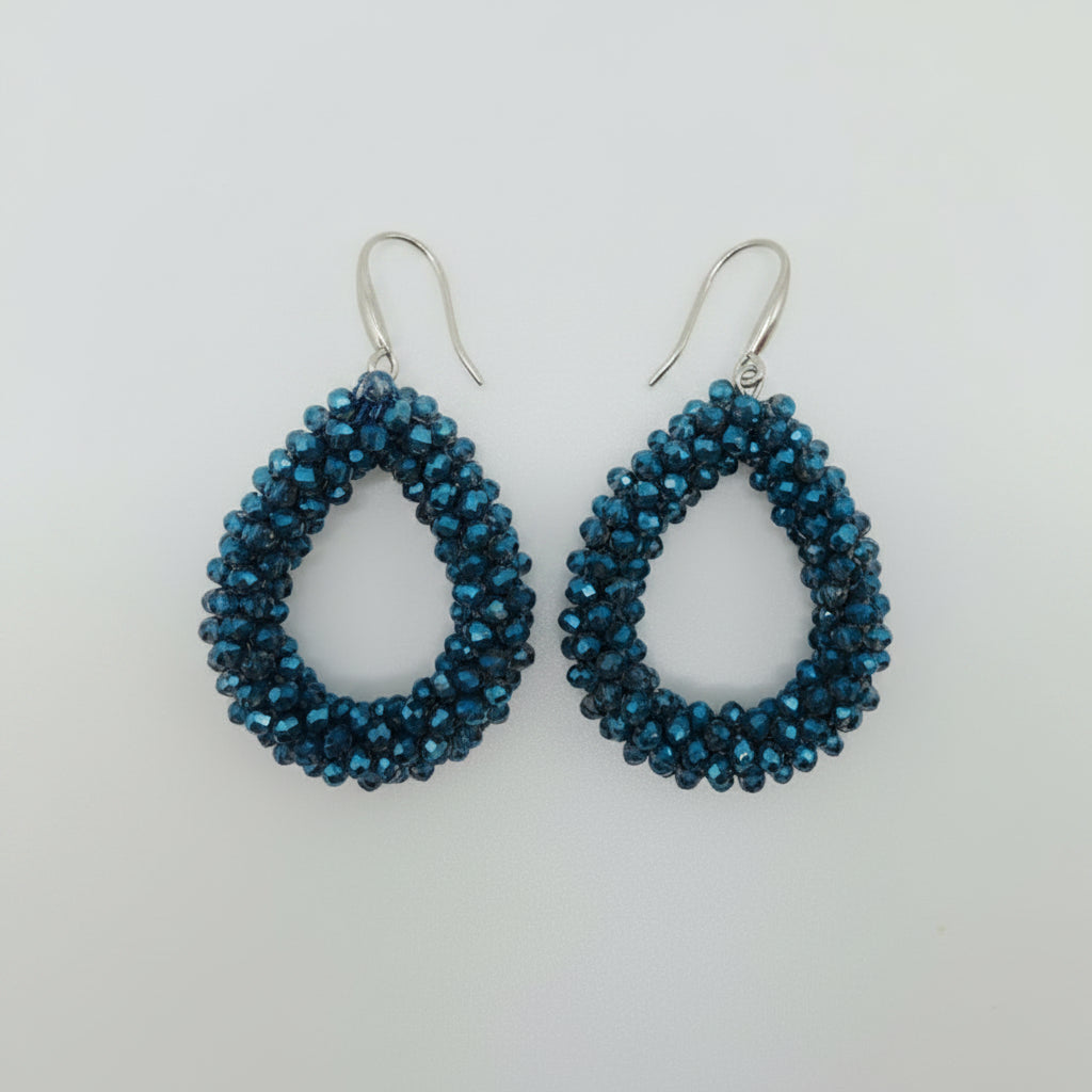 Pair of blue beaded earrings on a light gray background