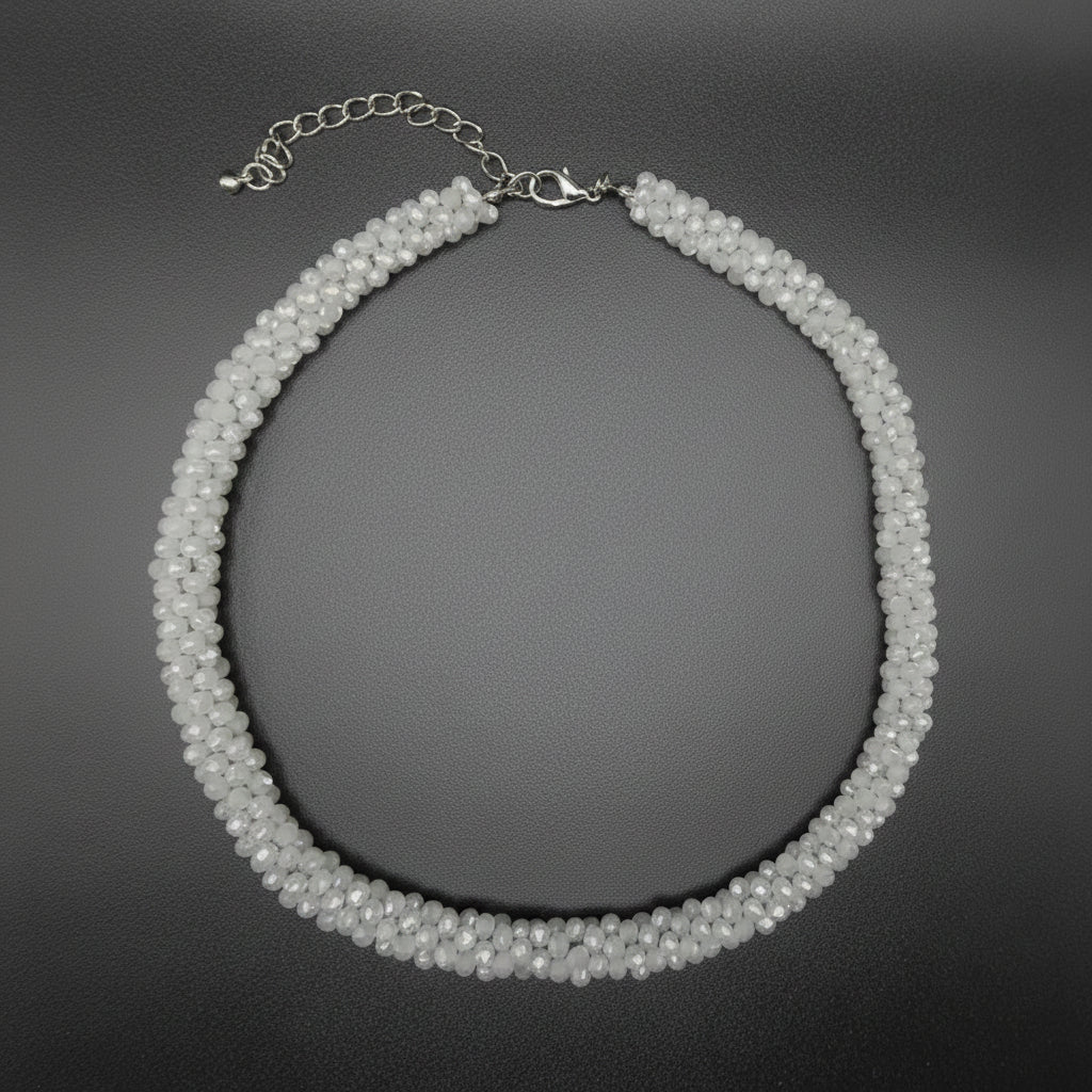 Silver necklace on a textured gray surface