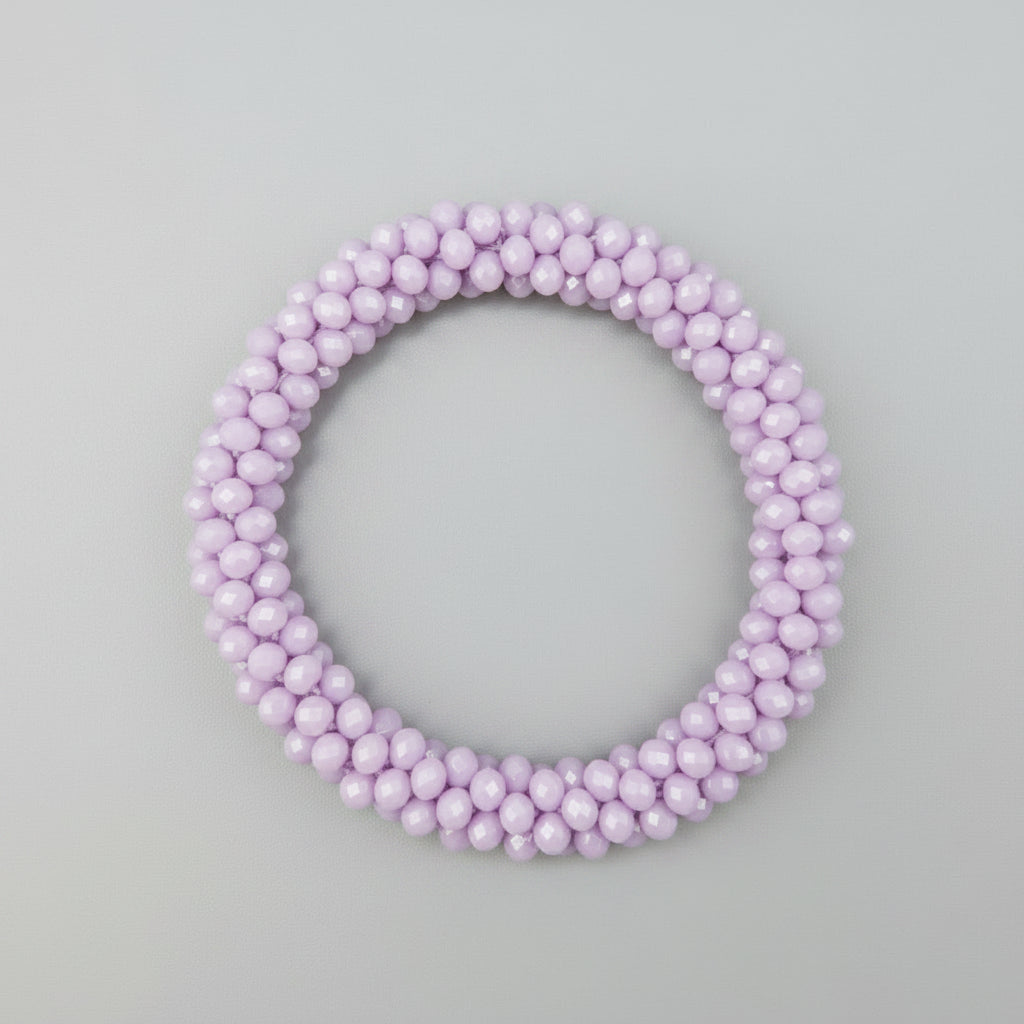 purple bracelet on a reflective gray surface