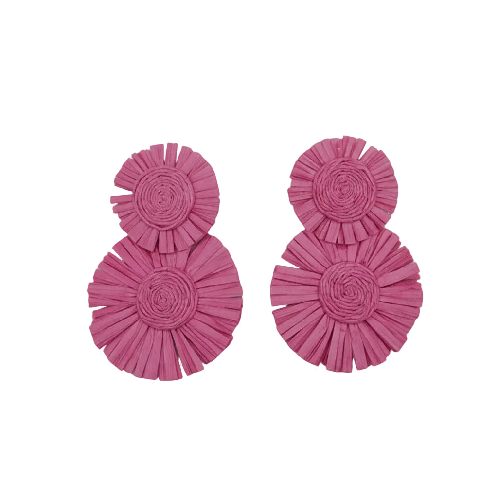 Pink ruffled earrings on a white cushion
