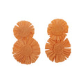 Pair of orange ruffled earrings on a light gray background