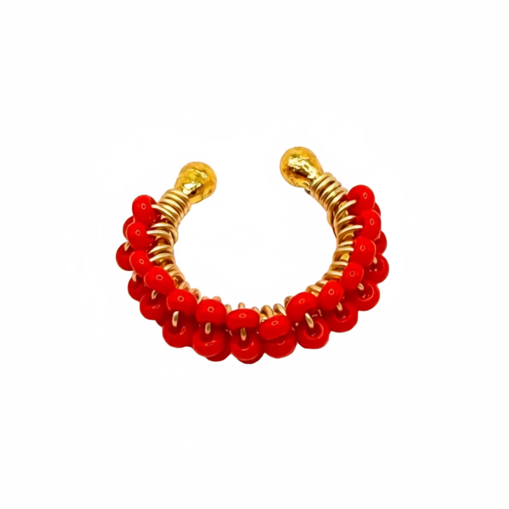Red beaded earring with gold accents on a white background