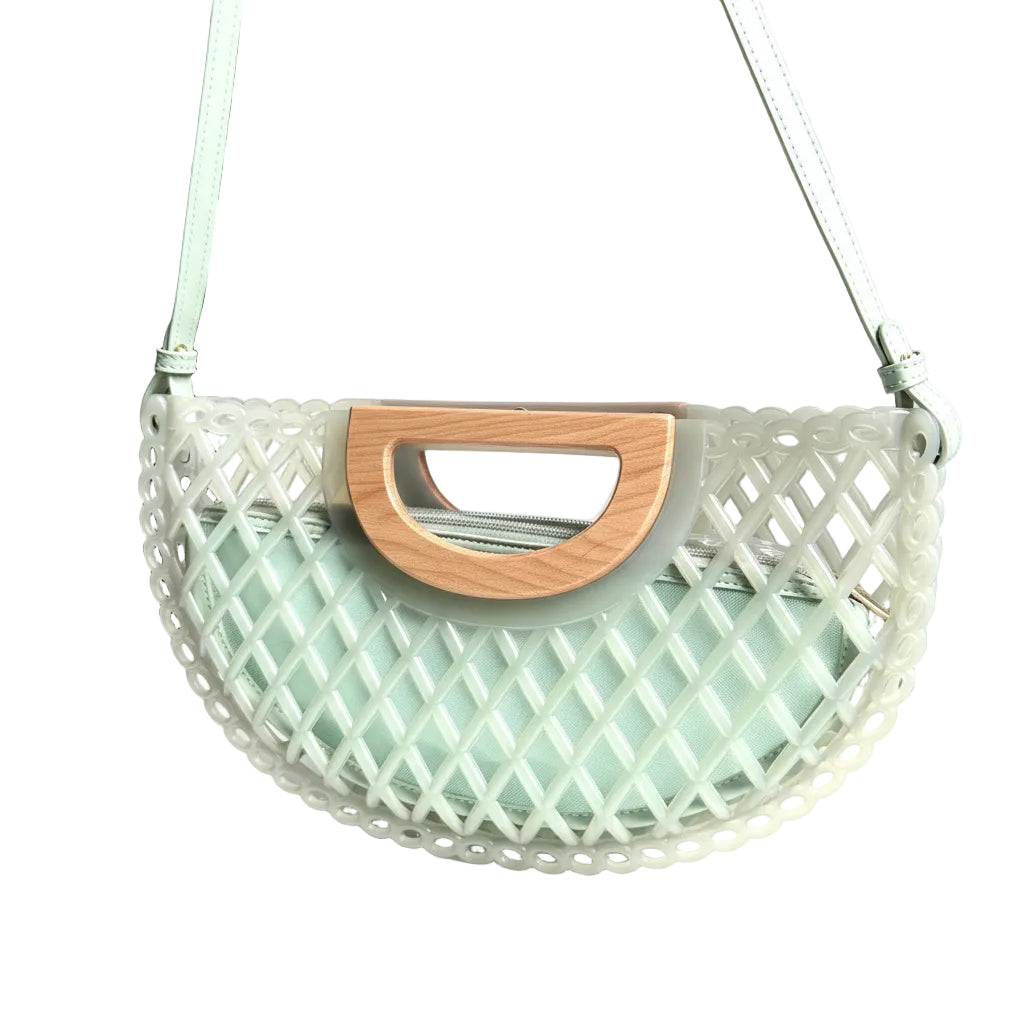 Mesh handbag with wooden handle on a white surface