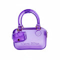 Purple handbag with transparent accents and 'Marc Eliza' branding on a light gray background