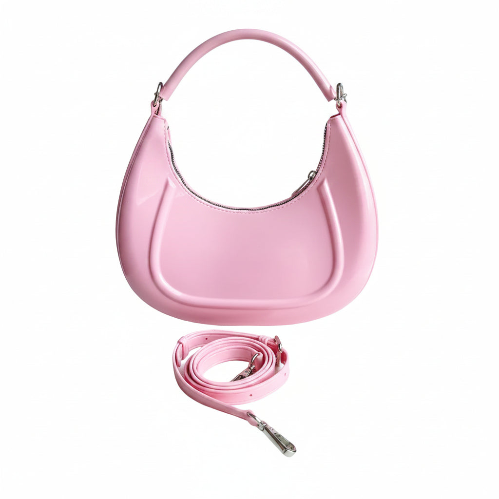 Pink handbag with matching strap on a white background