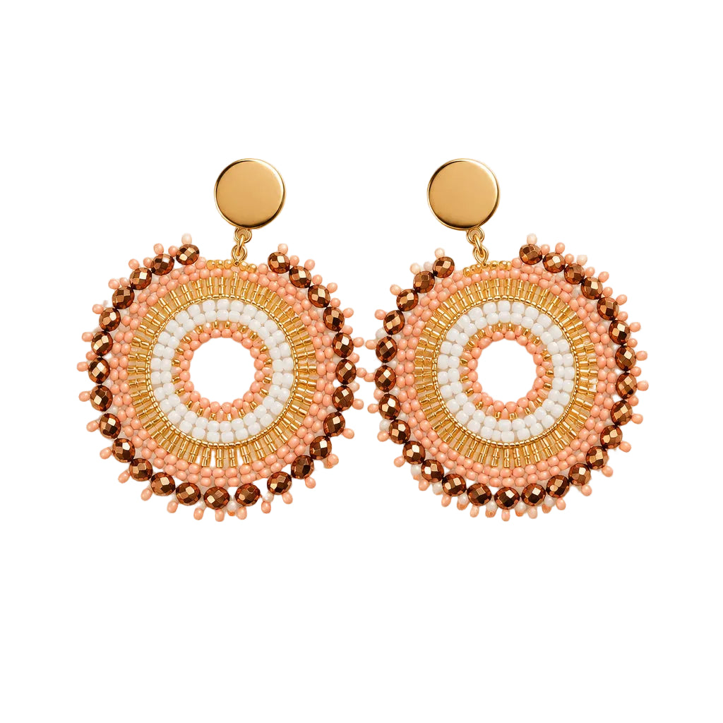 A pair of handmade circular drop earrings with a white and orange concentric circle design, accented with orange beads and gold-toned studs, displayed on a clear card against a white background.