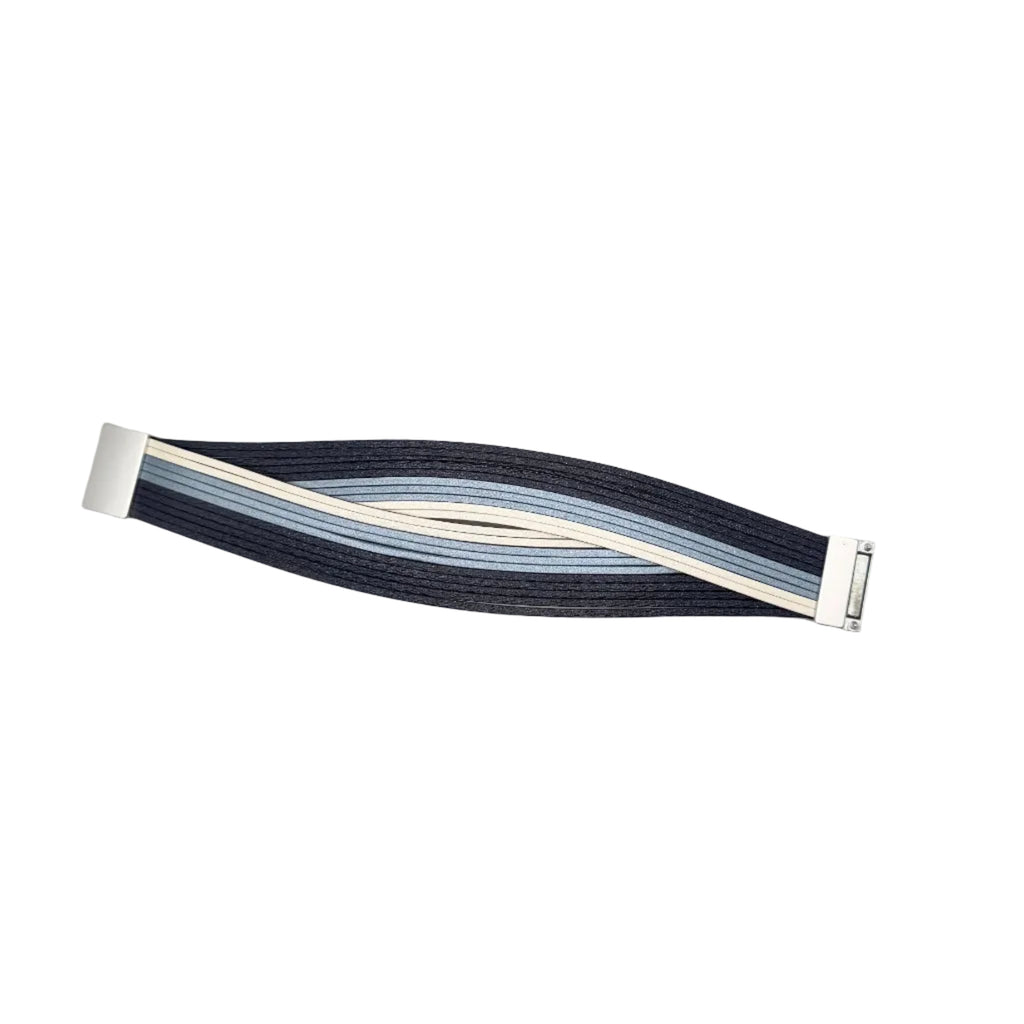 A minimalist metal watch band featuring a wavy, layered design in navy blue, light blue, and cream, secured with silver-toned hardware on a plain white background.