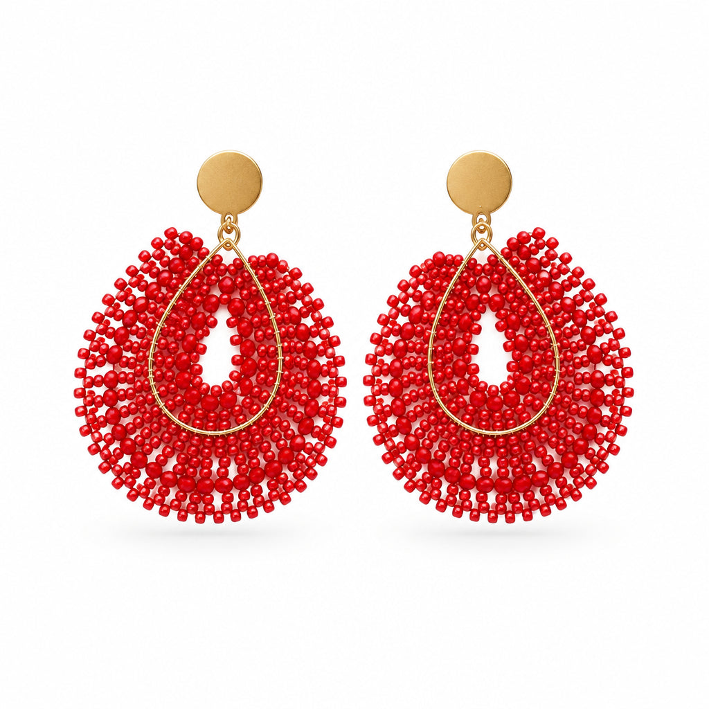 A pair of red beaded teardrop dangle earrings with dark brown circular studs, displayed on a clear plastic hanger against a plain white background.