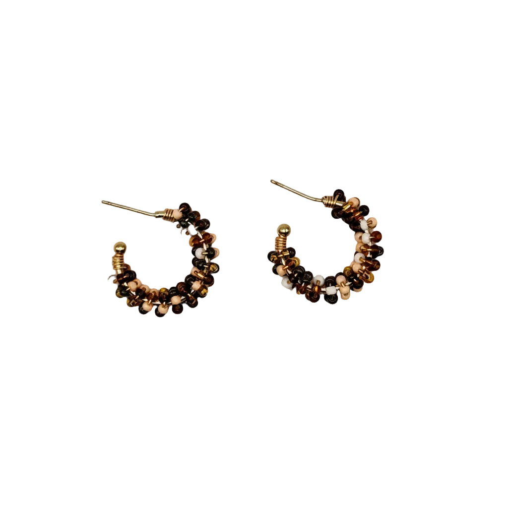 A pair of small crescent-shaped hoop earrings with clustered metallic beads in gold, bronze, and dark brown tones, shown on a plain light gray background.