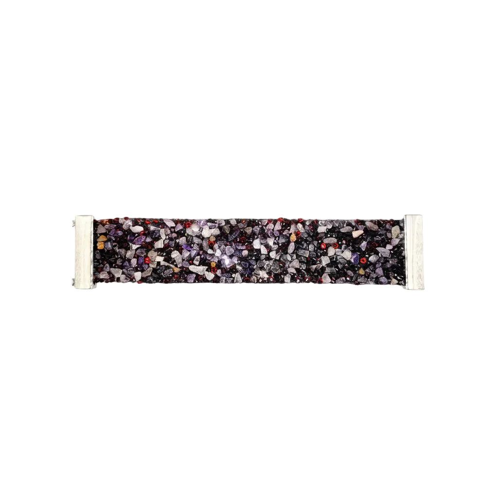 A rectangular woven strap with a multicolor terrazzo pattern of black, gray, white, and small red accents, finished with white end-caps, shown on a plain light gray background.