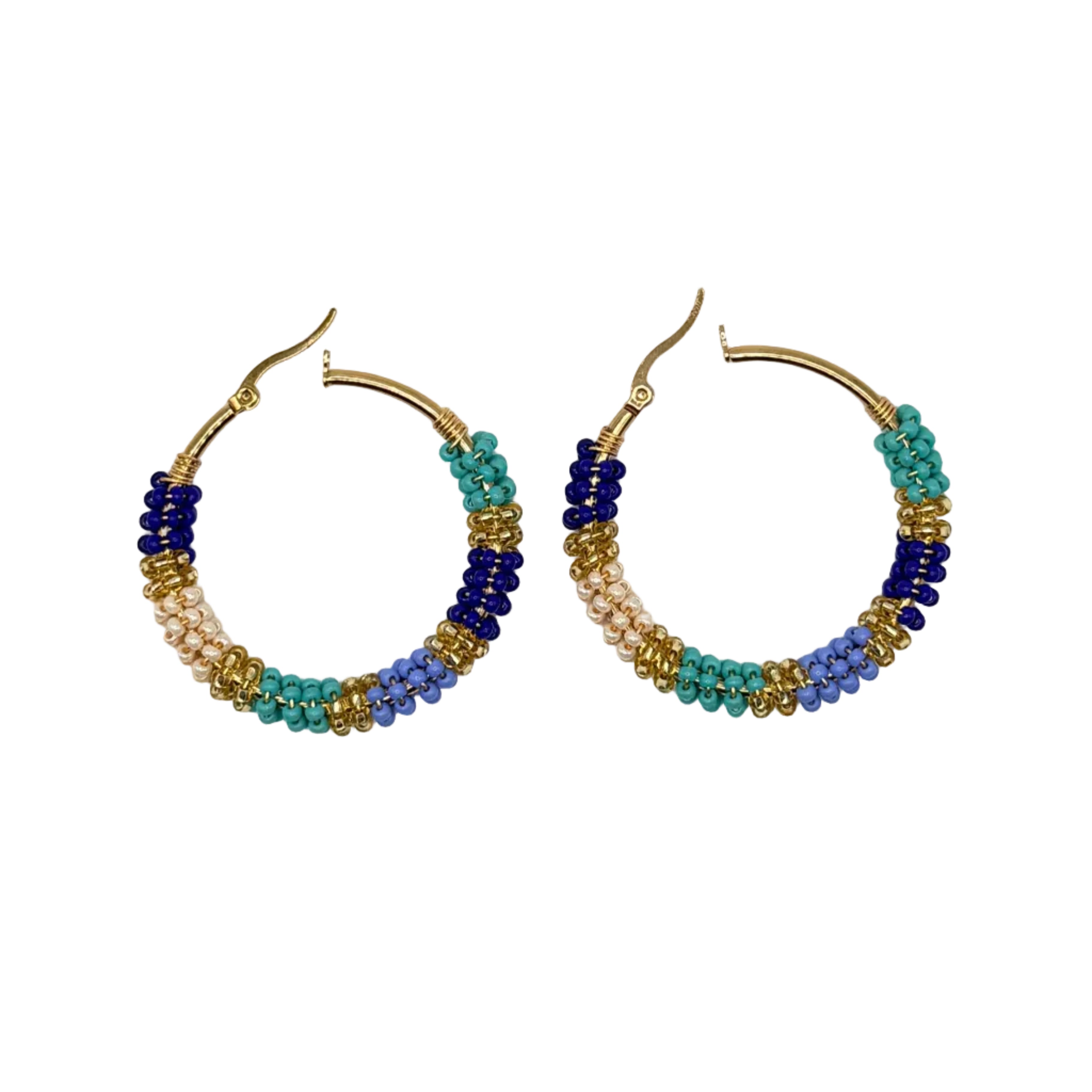 A pair of handmade gold hoop earrings decorated with multi-colored seed beads in blue, teal, lavender, and white, displayed on a clean white background.