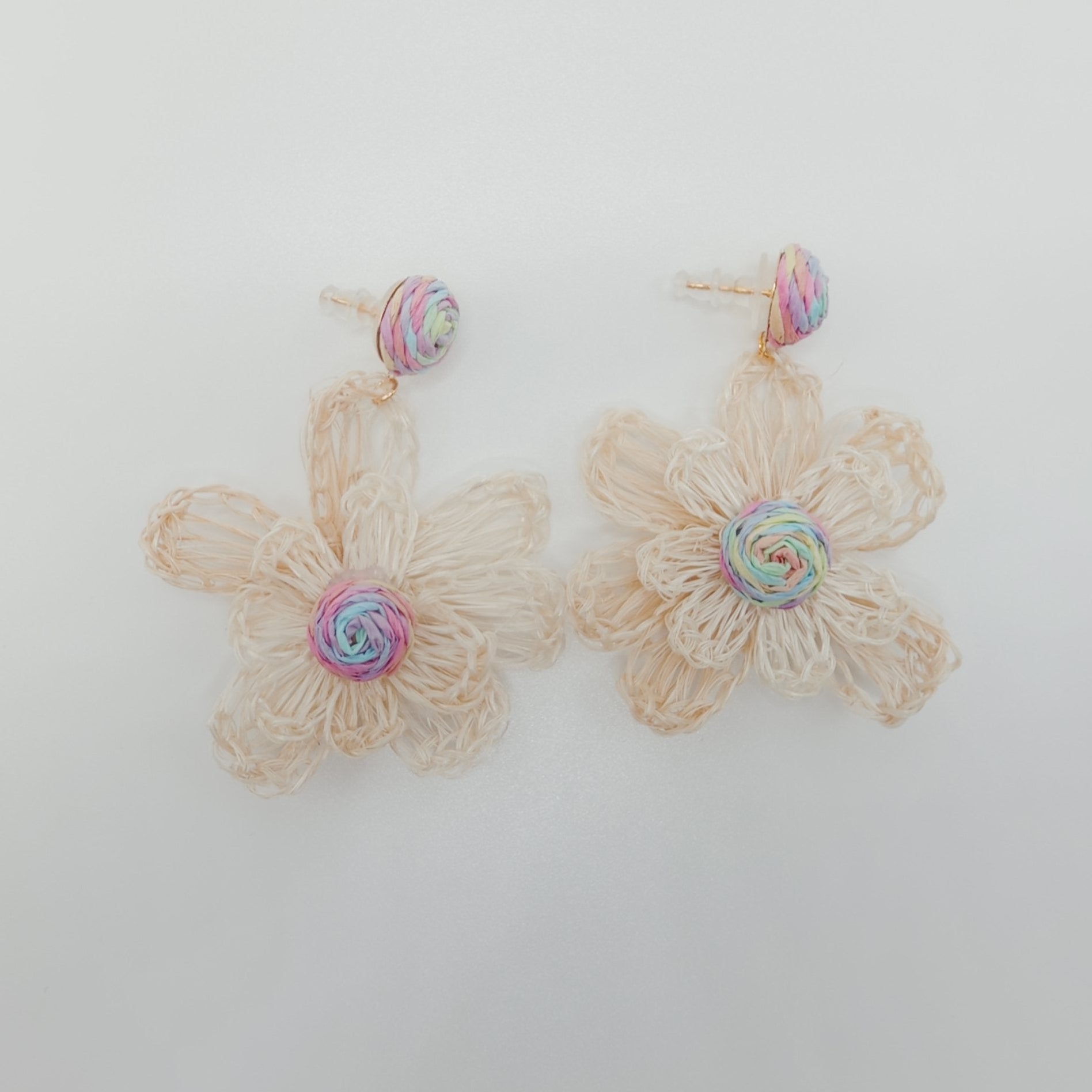 Floral earrings on a light gray background