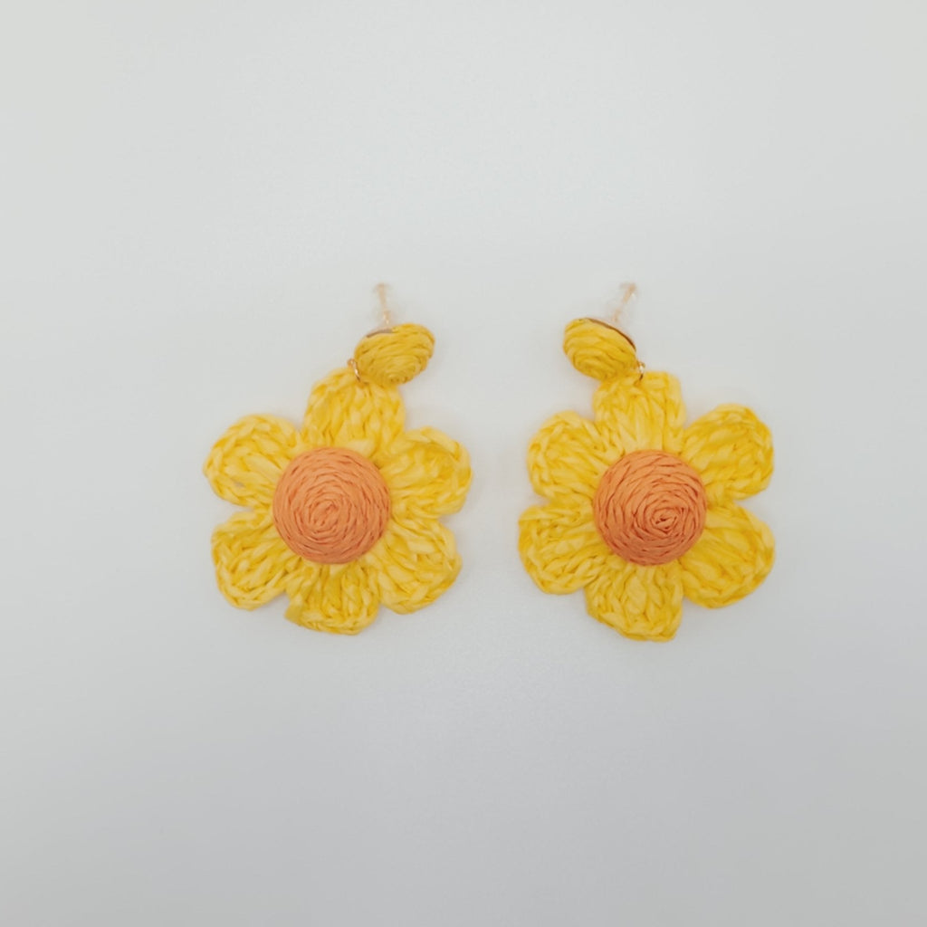 Yellow flower-shaped earrings on a white background