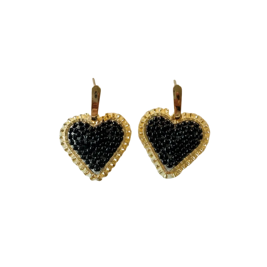 A pair of gold heart-shaped drop earrings with black beaded centers, displayed on a plain off-white background.