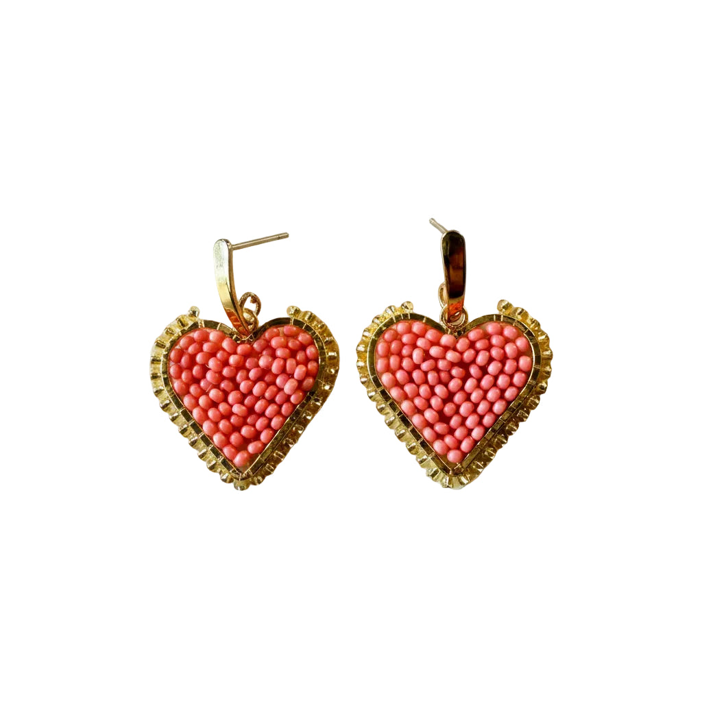 A pair of heart-shaped beaded earrings with pink and coral beads inside a gold-tone wire frame, shown on a plain light gray background.