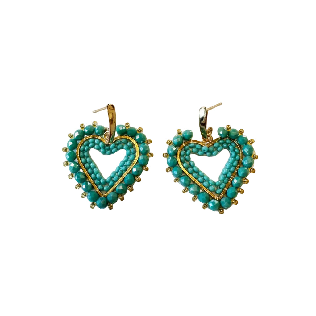 A pair of heart-shaped dangle earrings made with turquoise beads and gold metal borders, displayed on a plain off-white background.