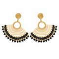 A pair of gold-toned statement earrings with circular hoops and dangling fan-shaped fringe, finished with black bead accents, displayed on a clear card against a white background.