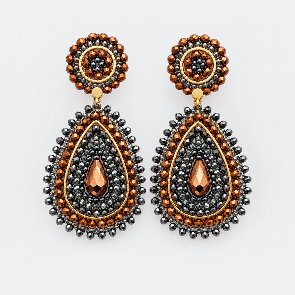 A pair of ornate teardrop dangle earrings with dark gray beaded borders, copper-toned accents, and a central rose gold teardrop, displayed on a white background.