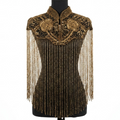 Decorative top with gold embroidery and fringe on a mannequin against a white background