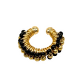 Gold and black beaded ear cuff on a white background