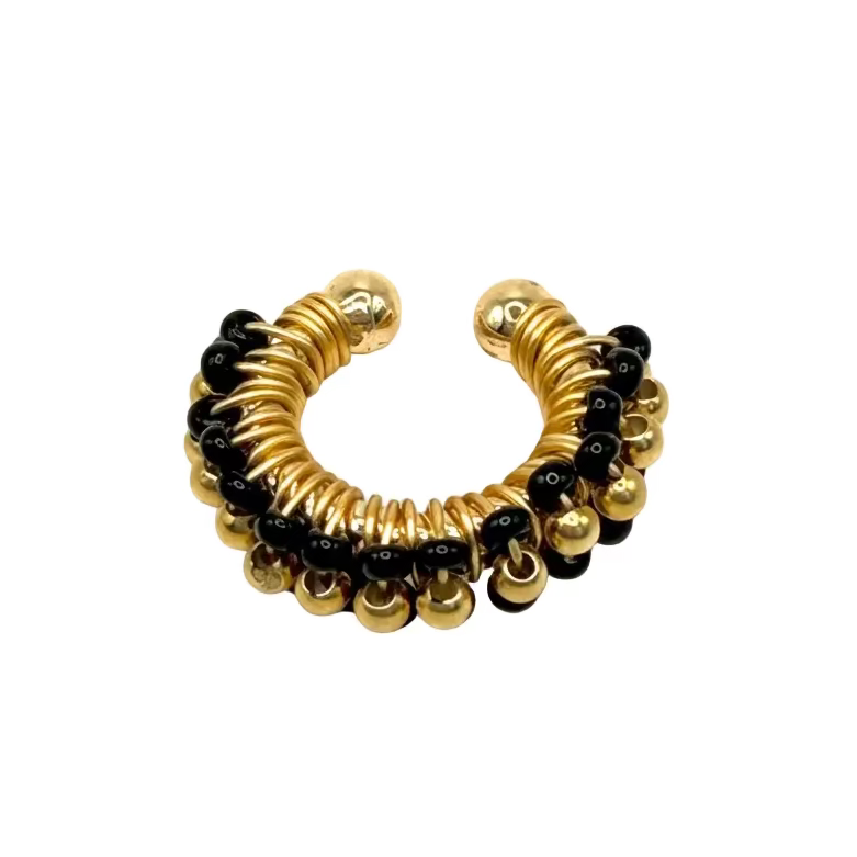 Gold and black beaded ear cuff on a white background