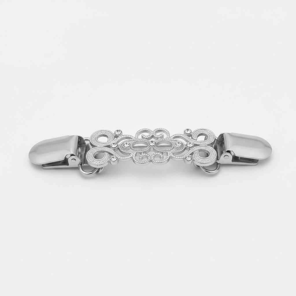 Two ornate metal hair claw clips shown side by side on a light gray background, one in silver-tone and one in gold-tone, each with an intricate filigree design and small clear rhinestone accents.