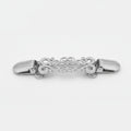 Two ornate metal hair claw clips shown side by side on a light gray background, one in silver-tone and one in gold-tone, each with an intricate filigree design and small clear rhinestone accents.