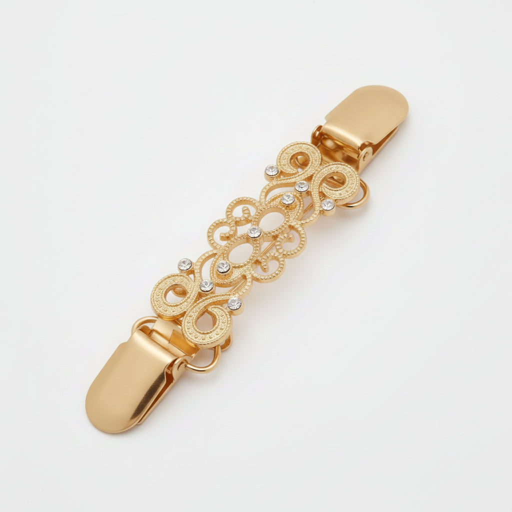 Two ornate metal hair claw clips shown side by side on a light gray background, one in silver-tone and one in gold-tone, each with an intricate filigree design and small clear rhinestone accents.
