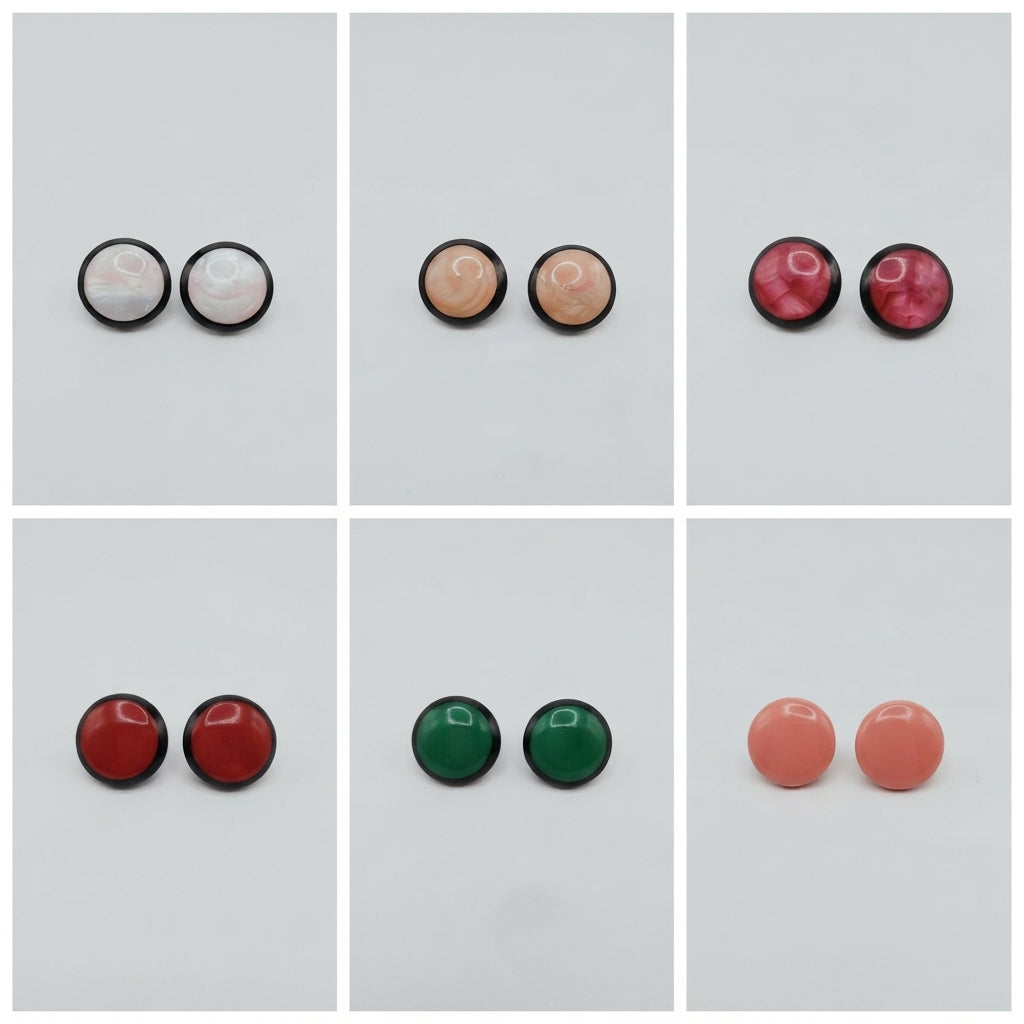 Six pairs of round stud earrings arranged in a 2x3 grid on a light gray background. The earrings have smooth, polished domed tops in various colors including white, peach, burgundy, red, green, and coral, each set in a black metal bezel.