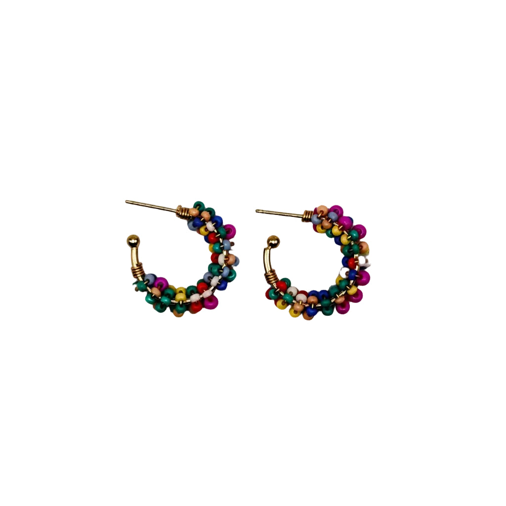 A pair of small gold hoop earrings decorated with tightly wound strands of colorful seed beads in pink, blue, green, and yellow, shown on a plain light gray background.