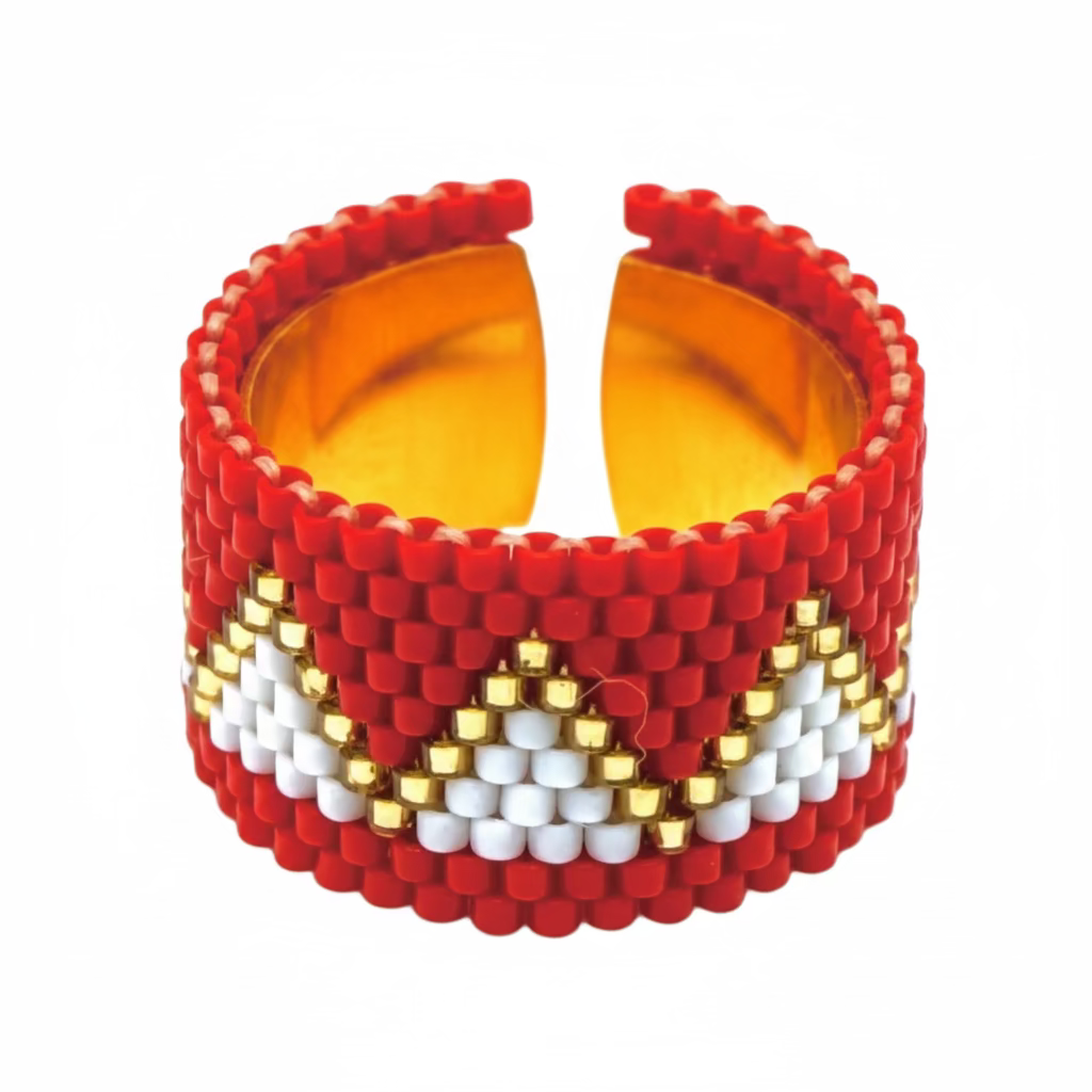 Beaded ring with a geometric pattern on a light gray background
