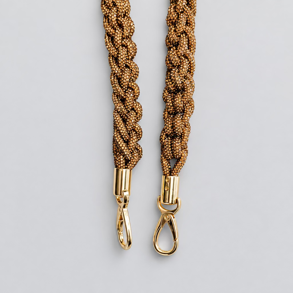 Two braided leather wristlets in a brown and gold pattern, featuring gold-tone metal swivel clasp ends, displayed against a plain off-white background.